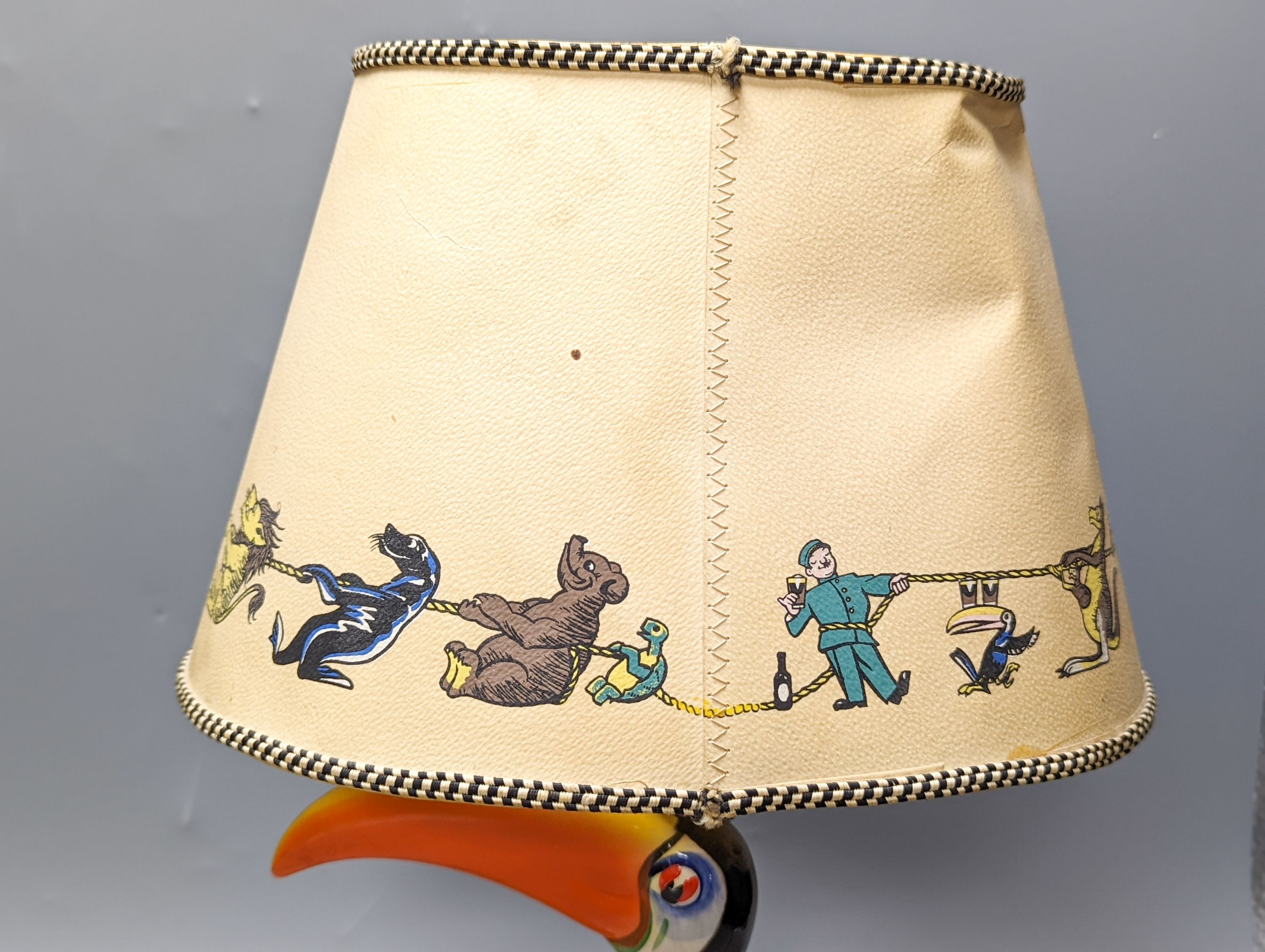 A Guinness toucan lamp, with original shade, tail repaired